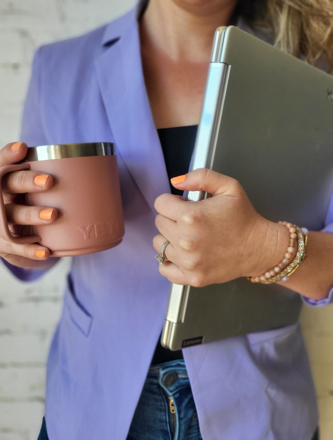 Julie from P&W Designs torso holding a coffee cup and computer