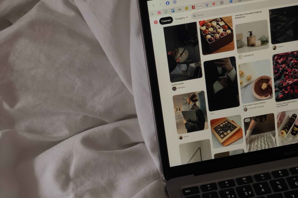 Pinterest home feed on a laptop showing styled food and fashion pins